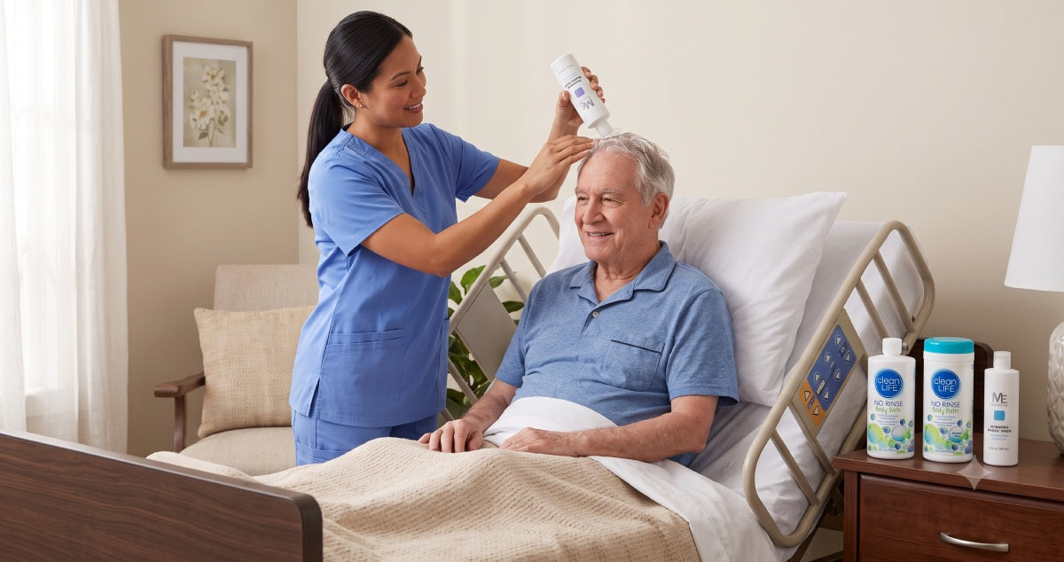 Caregiver applying no-rinse shampoo and body bath to assist a patient with limited mobility